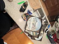 Overview of figurines and three boxed plates on countertop