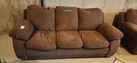 Front view of brown three-seat sofa