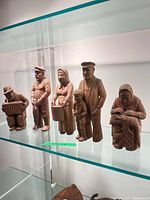 Group shot of all five A. Lassin wooden figurines