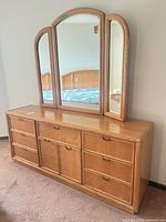Front view of oak 9-drawer dresser with attached tri-fold mirror