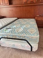 Adjustable bed with mattress and remote on top
