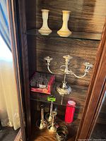 Shelf with candlesticks, candelabra, red glass holder, boxed crystal oil glasses