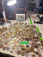 Overall view of piled loose coins with coin display card visible