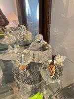 Group view showing multiple crystal and glass items in display cabinet