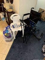 Overall lot showing wheelchair, shower chair, canes, adult brief packages
