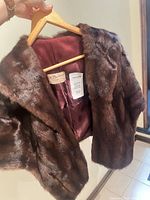 Full shawl front showing fur exterior and satin lining