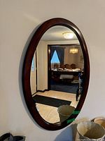 Front view of oval mirror mounted on wall