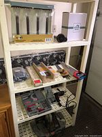 Full shelving unit with tools, saws, bit set, solar lights visible