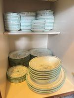 Stacked dessert bowls, soup/cereal bowls and plates on shelves
