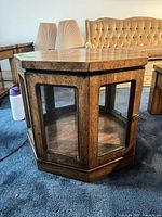 Full view of octagonal wood side table with glass panels
