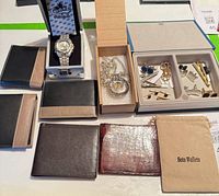 Overview of wallets, wristwatch in box, pocket watch, cufflinks set