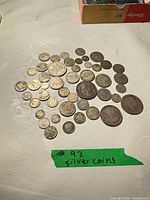 Full lot showing roughly 50 assorted coins on tabletop