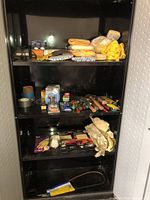 Cabinet shelves containing assorted tools and hardware