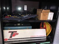 Shelf with straps, boxes, toolbox, extension cord reel and fender trim box