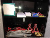 Cabinet shelf with two floor jacks and three jack stands