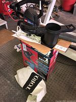 Boxed Toro Super electric blower vac with bag and tube visible on top