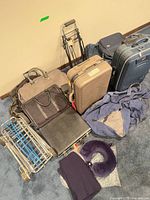 Group of suitcases, bags, folding cart, neck pillow
