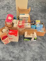 Stacked boxes and packs of various light bulbs on carpet