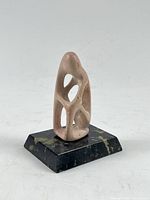 Front view of soapstone sculpture mounted on marble base