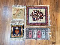 All four rugs laid out together showing overall designs and colours