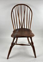 Front view of Windsor chair showing hoop back and saddle seat