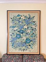 Full view of framed floral serigraph above sofa