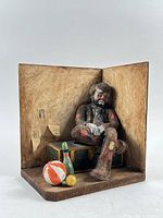 Full frontal view of diorama showing clown, trunk, props, backdrop