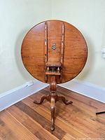 Table in folded position showing full pedestal and legs