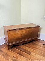 Full view of pine blanket chest showing form, color and apron