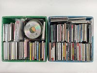 Top view of two crates filled with CDs in jewel cases and loose discs