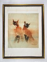 Framed coloured lithograph showing two Siamese cats, full view