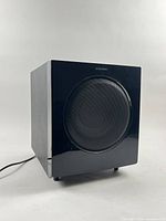 Front angled view of Samsung PS-AW720S subwoofer showing glossy front panel and grille