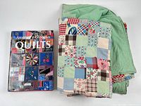 Quilt folded next to hardcover book