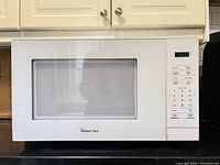Front view showing entire microwave, control panel and display