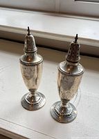 Both sterling shakers side by side front view