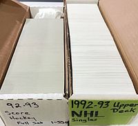 Two long card storage boxes labelled 92-93 Score Full Set 1-550 and 1992-93 Upper Deck NHL Singles
