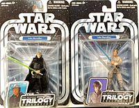 Front view of both sealed Luke Skywalker OTC figures on cards
