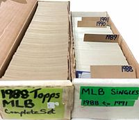 Open box showing full 1988 Topps complete set on left and row of singles with year dividers on right