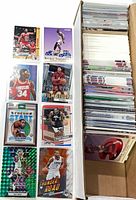 Left column of eight featured cards alongside full box of stacked cards