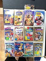 All 12 sealed VHS tapes arranged in grid with camel toy visible