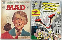 Both comic books in plastic sleeves side by side