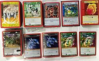 Stacks of MetaZoo cards in red sleeves; several holographic cards visible