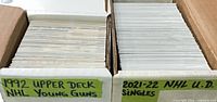 Two open storage boxes labeled for 1992 Upper Deck Young Guns and 2021-22 NHL singles
