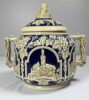 Full front view showing Marksburg panel, grape relief, handles, lid