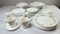 Entire 31-piece Corelle fruit motif dinnerware set displayed