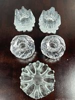 All five clear glass candle holders grouped
