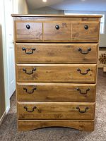 Front view showing five drawers and hardware
