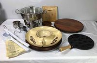 Group view showing all primary items: chafing dish, chip and dip platter, poffertjes pan, live-edge board, spätzle press, utensils
