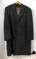 Full front view of wool coat on hanger