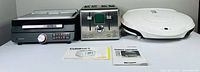 Three small kitchen appliances—Ninja grill-griddle, Cuisinart toaster, George Foreman grill—on tabletop
